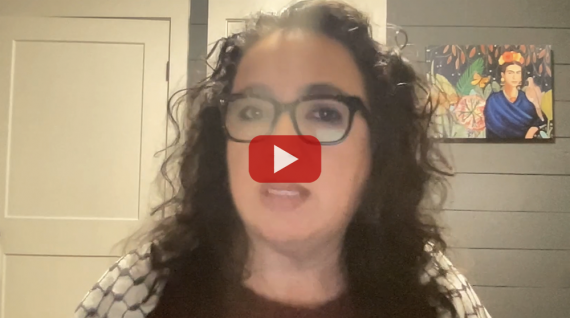 Video screenshot of GGJ Executive Director Cindy Wiesner, with a keffiyeh draped on her shoulders.