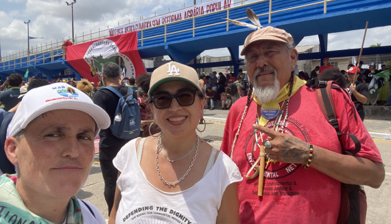 Three GGJ delegation members at the People’s Summit march in Brazil